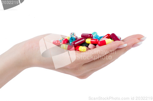 Image of hand holds pill 