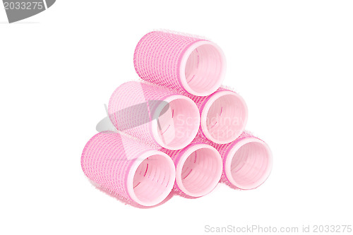 Image of Six pink velcro rollers stacked in a pyramid