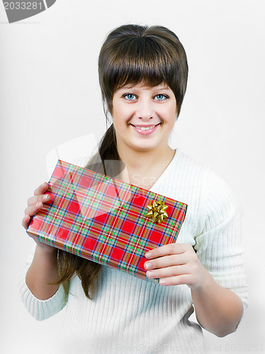 Image of beautiful blue eyed young happy smiling girl with a gift box