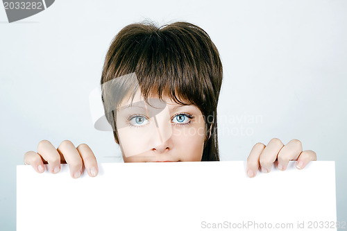 Image of Face Beautiful Young Woman Hiding Behind A Large White banner