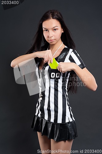 Image of Sexy Soccer Referee with yellow card