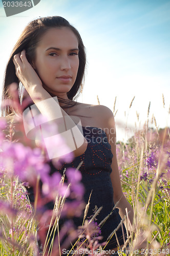 Image of Beautiful brunette woman in pink flowers