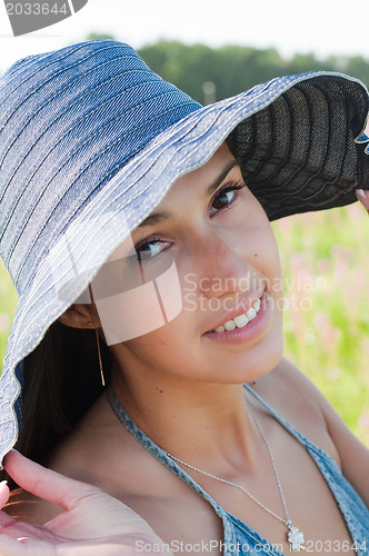 Image of Smiling young woman in hat