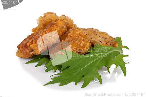 Image of Breaded chicken sticks with mitsuna salad leaves on white