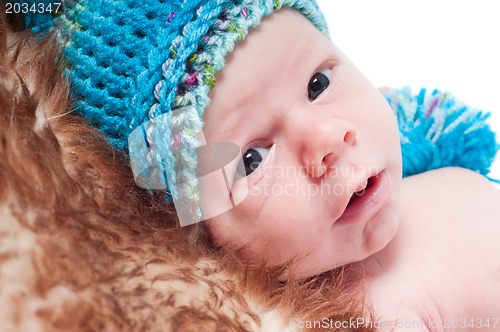 Image of Newborn baby in knitted blue hat