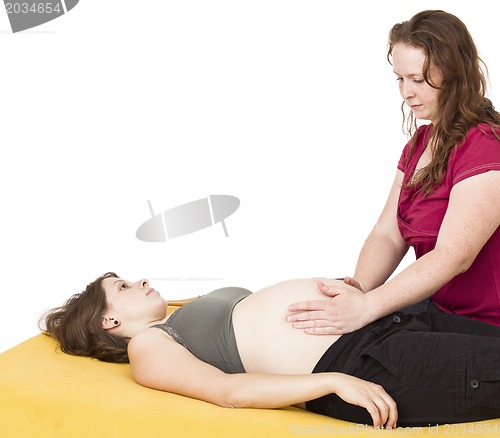Image of midwife sitting behind pregnant woman