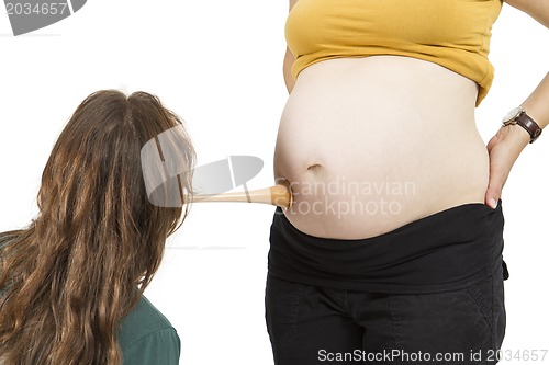 Image of midwife listening at human belly