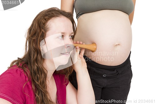 Image of midwife listening at human belly