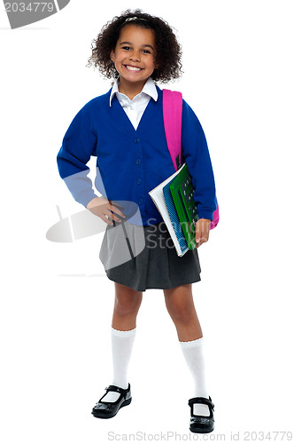 Image of Girl in smart uniform holding notebook and calculator