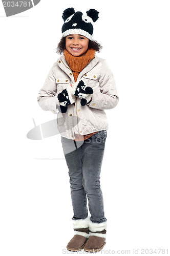 Image of Little fashionable girl in warm clothes