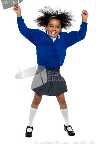 Image of Pretty African school girl dances in full swing