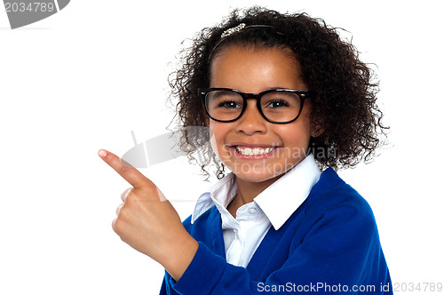 Image of African primary girl showing the way to her classroom