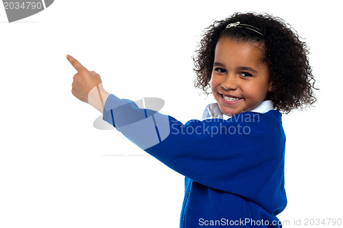 Image of Adorable African kid pointing at copy space area