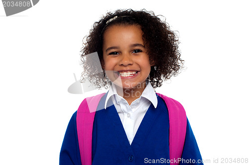 Image of Beautiful girl in uniform with backpack smiling at you