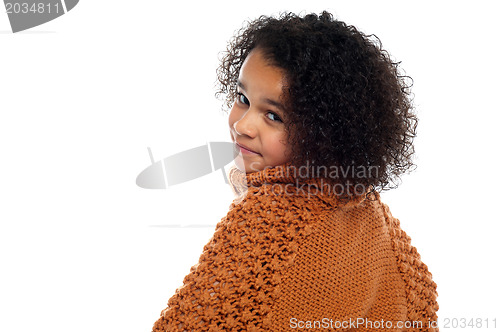Image of Little girl with over sized sweater on turning back