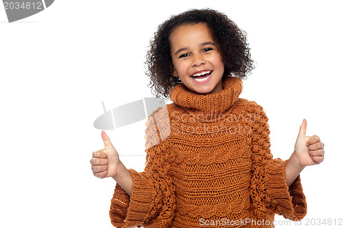 Image of Pretty kid laughing and showing double thumbs up