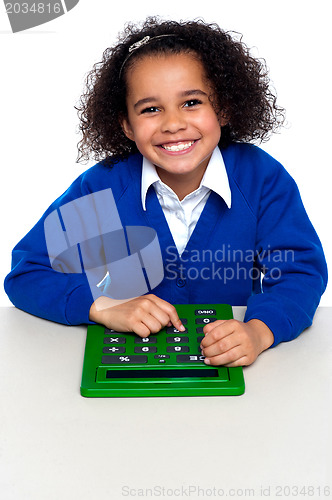 Image of African elementary school kid using a calculator
