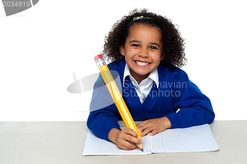 Image of Pretty girl writing in her notebook