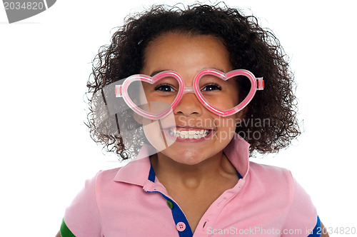 Image of Pretty girl with a wide grin. Wearing funny frame