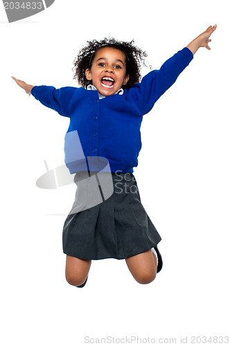 Image of Jubilant school kid jumping high up in the air