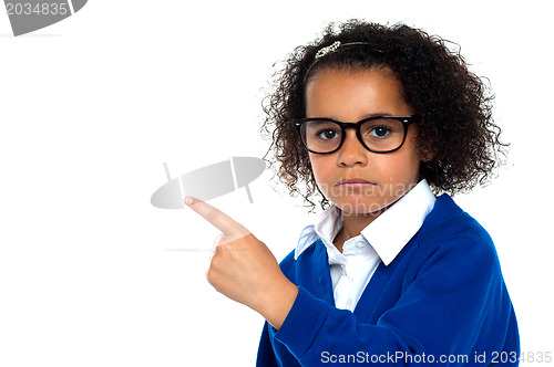 Image of Studio shot of a melancholic girl pointing sideways