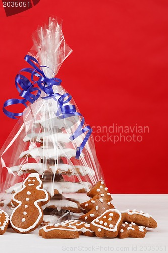 Image of christmas gingerbreads tree on red background