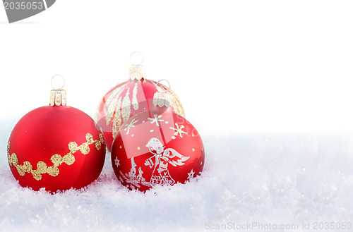 Image of christmas balls on white snow 