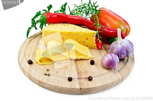 Image of Cheese with pepper and herbs on a round board