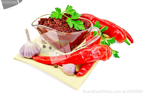 Image of Ajika in a glass gravy boat on a napkin