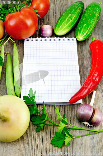 Image of Notebook with vegetables and pepper