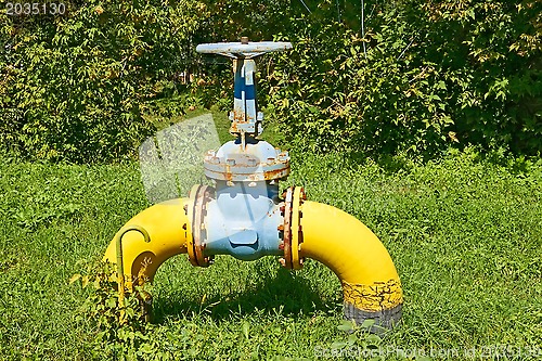 Image of Gas pipe with a valve against nature