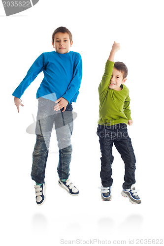 Image of Two boys jumping on white background.