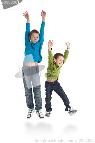 Image of Two boys jumping on white background.