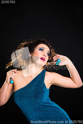 Image of beautiful girl playing with Christmas decoration