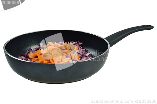 Image of Onions and carrots in pan