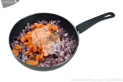 Image of Onions and carrots in pan