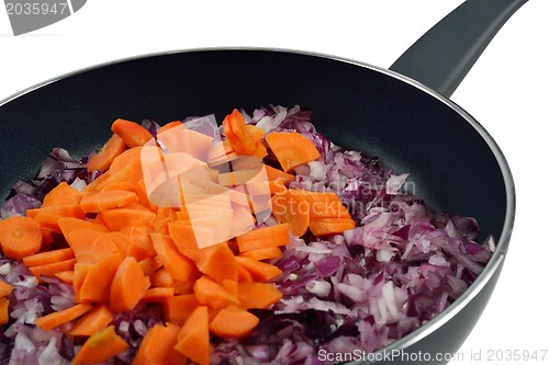 Image of Onions and carrots in pan