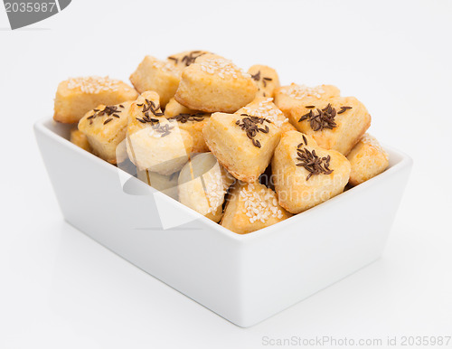 Image of Cheese cookies with cumin and sesame on white background