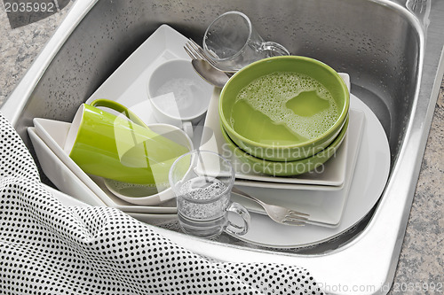 Image of Bright dishes in the kitchen sink 