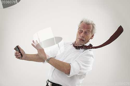 Image of Senior businessman struck by high winds