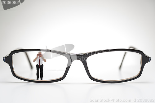 Image of Diminutive elderly man peering through spectacles