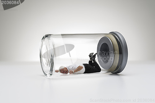 Image of Senior man trapped in a glass jar