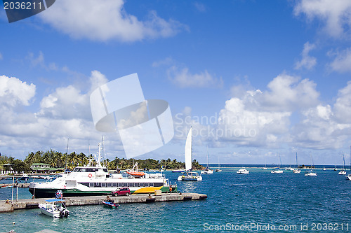 Image of harbor port  jetty hotel passenger ferry and yacht sailboats Cli