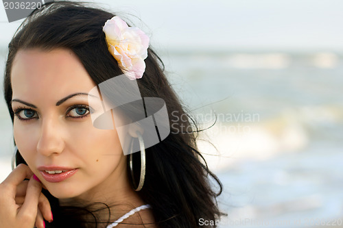 Image of lovely young woman on the beach