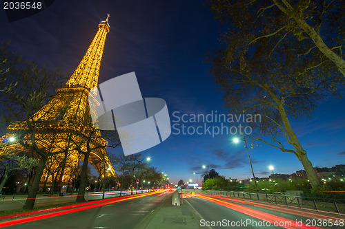 Image of Wonderful colors of Eiffel Tower. Winter sunset with car light t