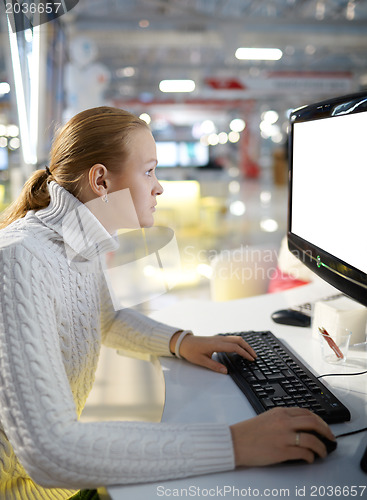 Image of Young girl and blank monitor.