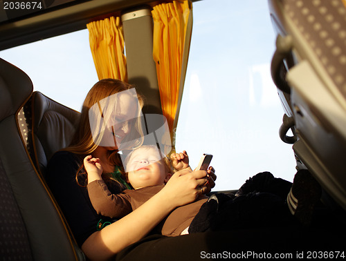 Image of Mother and kid are playing game on the phone.