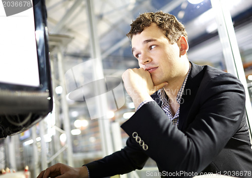 Image of Smart young man is working on the computer.