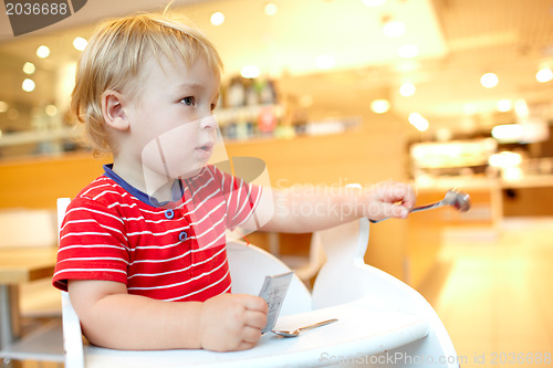 Image of Little boy in the restaurant.