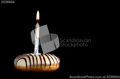 Image of One candle in the doughnut.